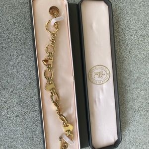 BRAND NEW NEVER BEEN USED Juicy Couture Charm Bracelet. Box included.